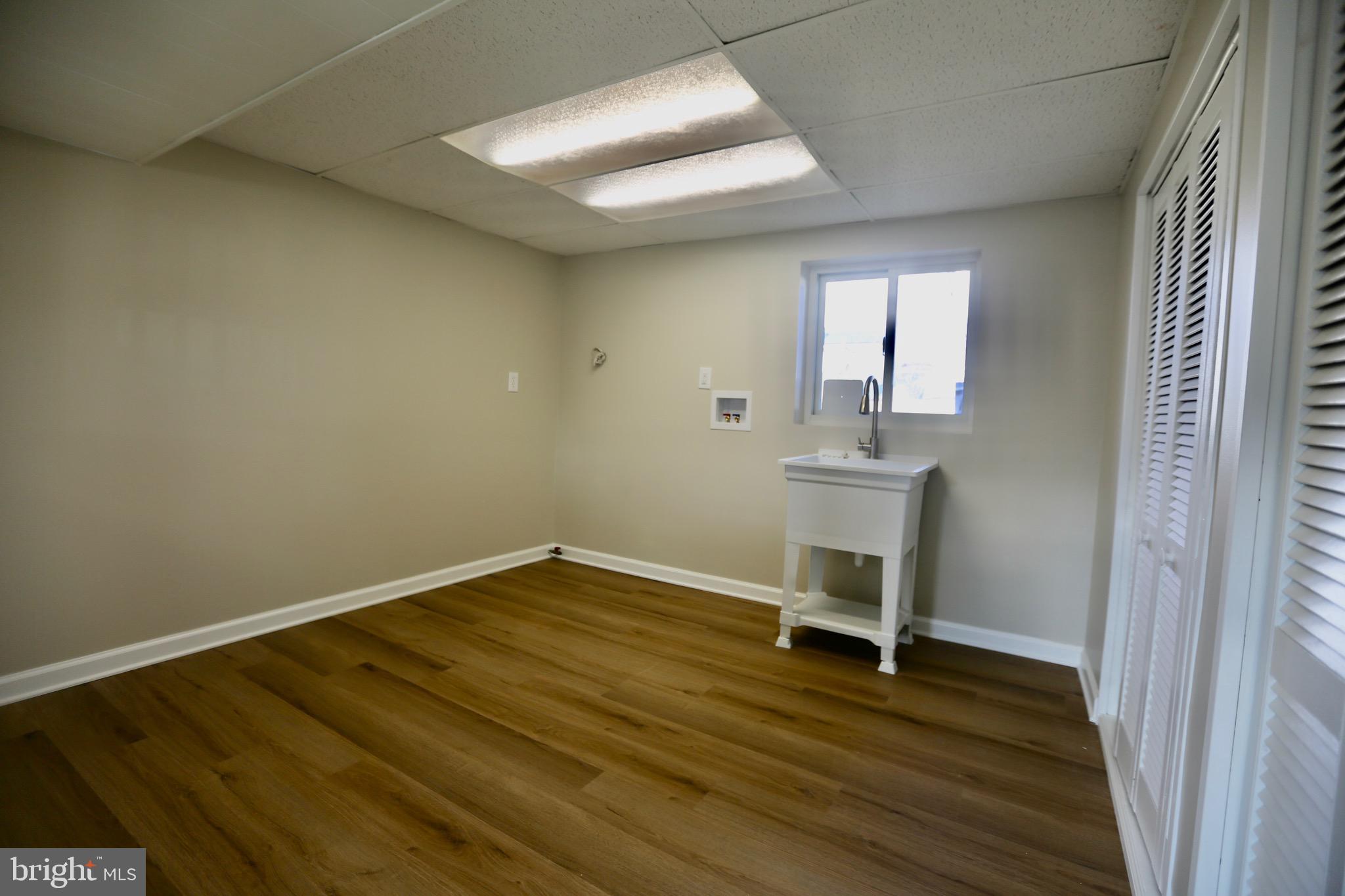 242 Tilford Road Somerdale, NJ 08083 - Photo 22 of 29 wooden floor in an empty room with a window