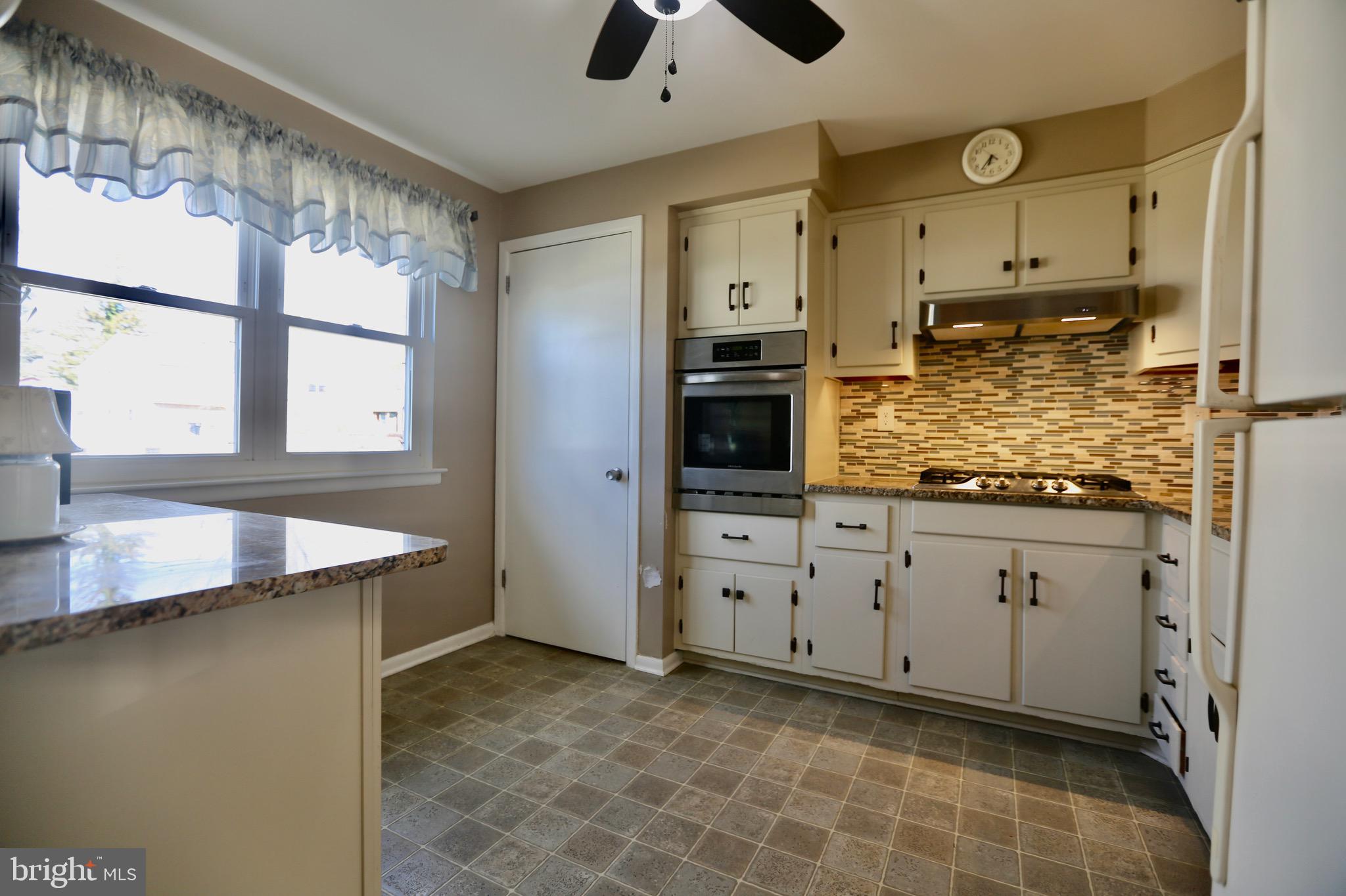 242 Tilford Road Somerdale, NJ 08083 - Photo 10 of 29 a kitchen with granite countertop a sink and cabinets