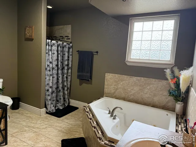 a bath room with a bath tub and a shower