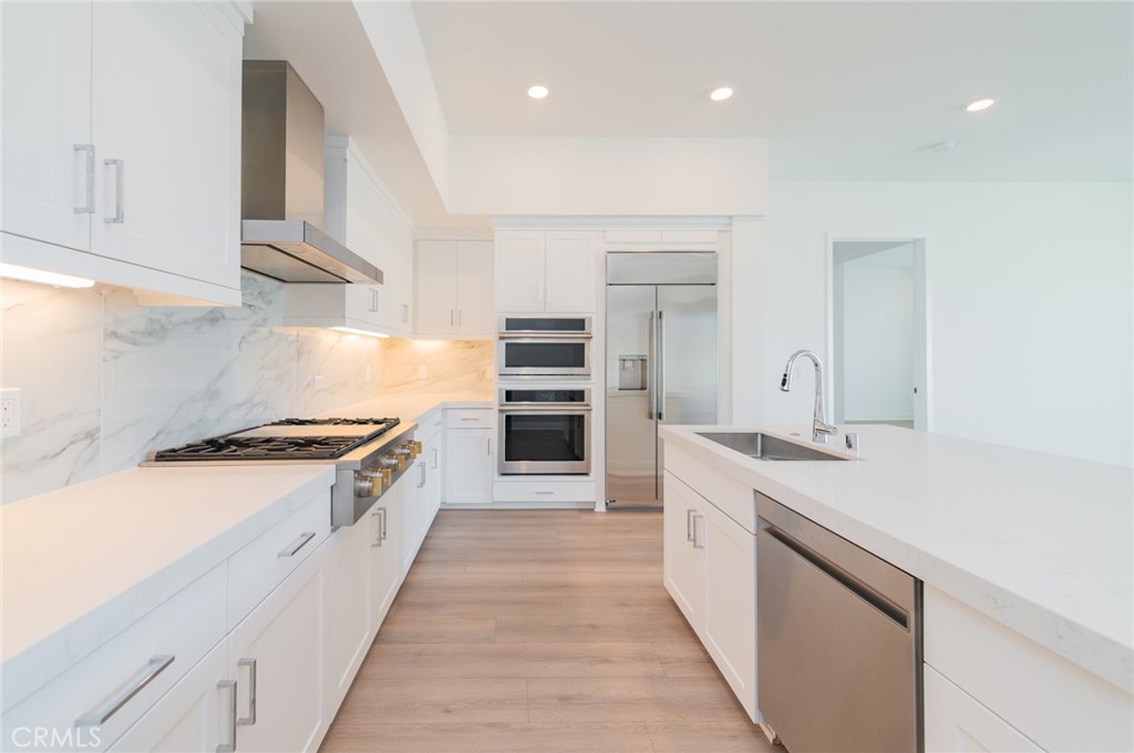 1703 Rivington Irvine, CA 92612 - Photo 2 of 42 a large kitchen with stainless steel appliances granite countertop a stove and a sink