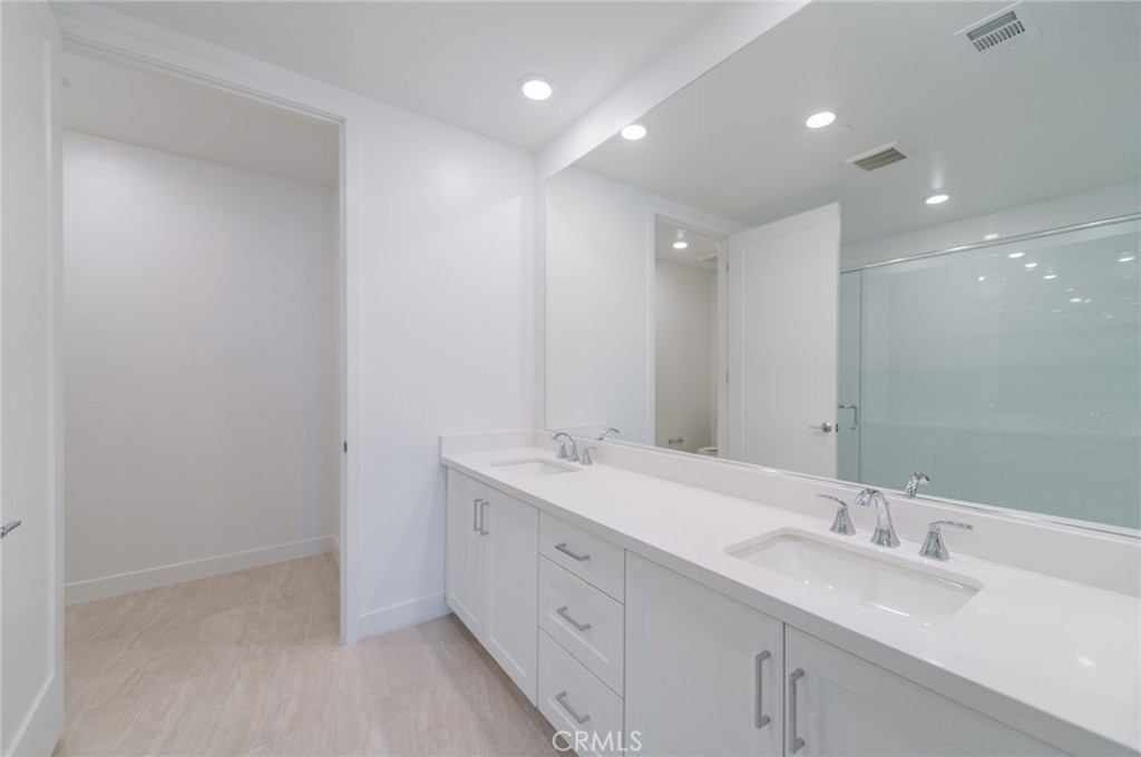 1703 Rivington Irvine, CA 92612 - Photo 22 of 42 a bathroom with a double vanity sink and a mirror