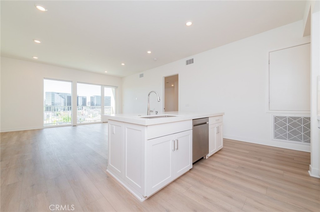 1703 Rivington Irvine, CA 92612 - Photo 9 of 42 a kitchen with stainless steel appliances granite countertop a stove a sink and a large window