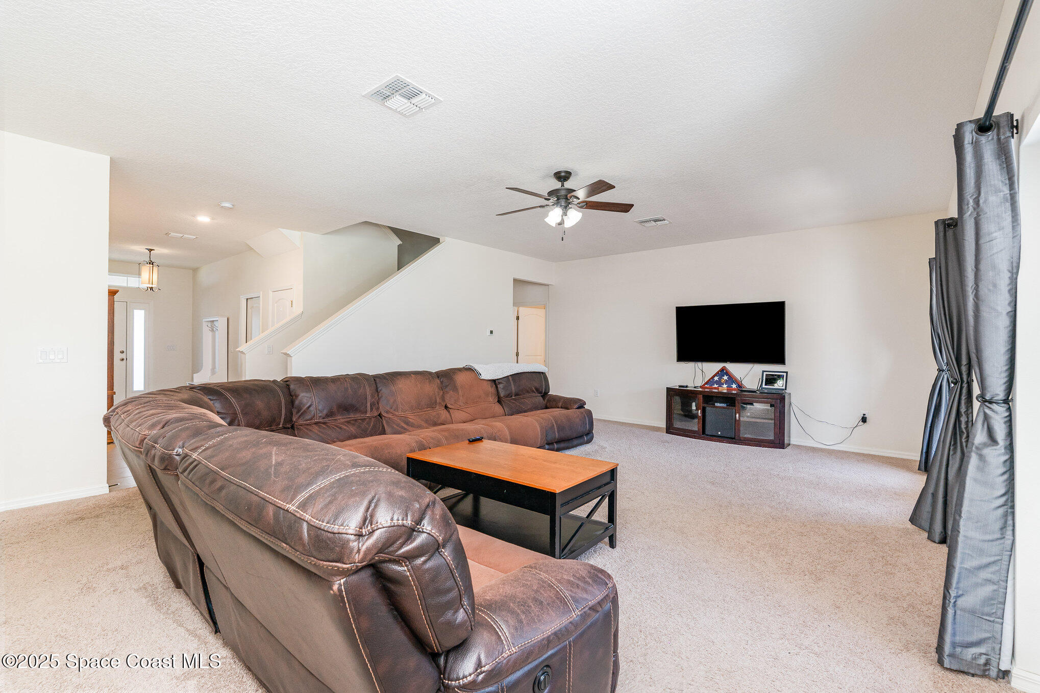 352 Gordon Road Northwest Palm Bay, FL 32907 - Photo 13 of 71 a living room with furniture and a flat screen tv