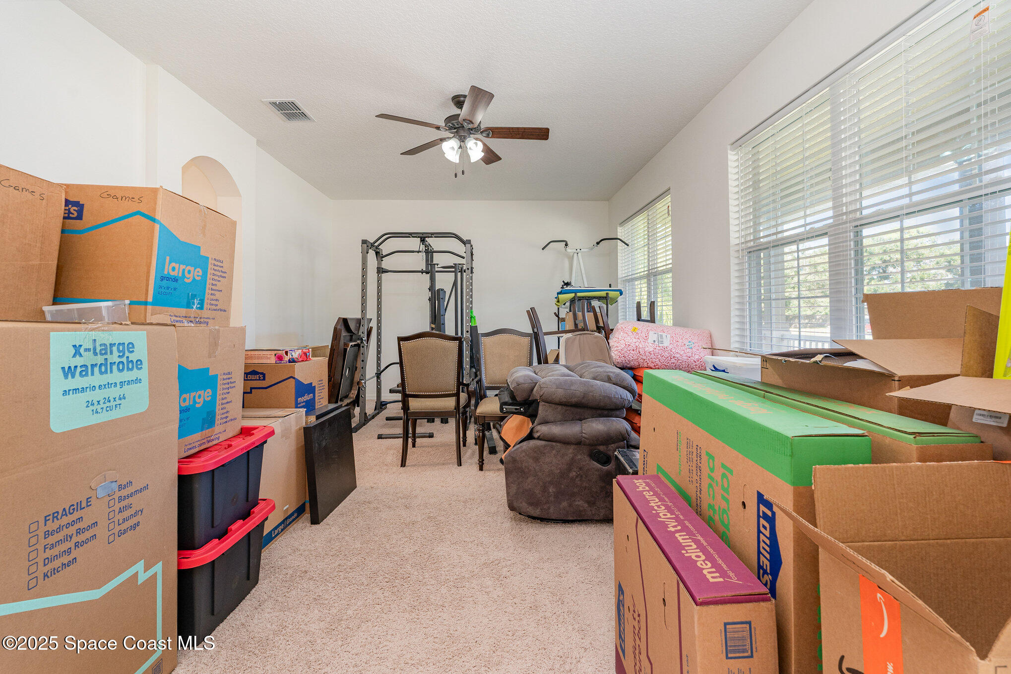 352 Gordon Road Northwest Palm Bay, FL 32907 - Photo 14 of 71 a bedroom with furniture and a gym equipment