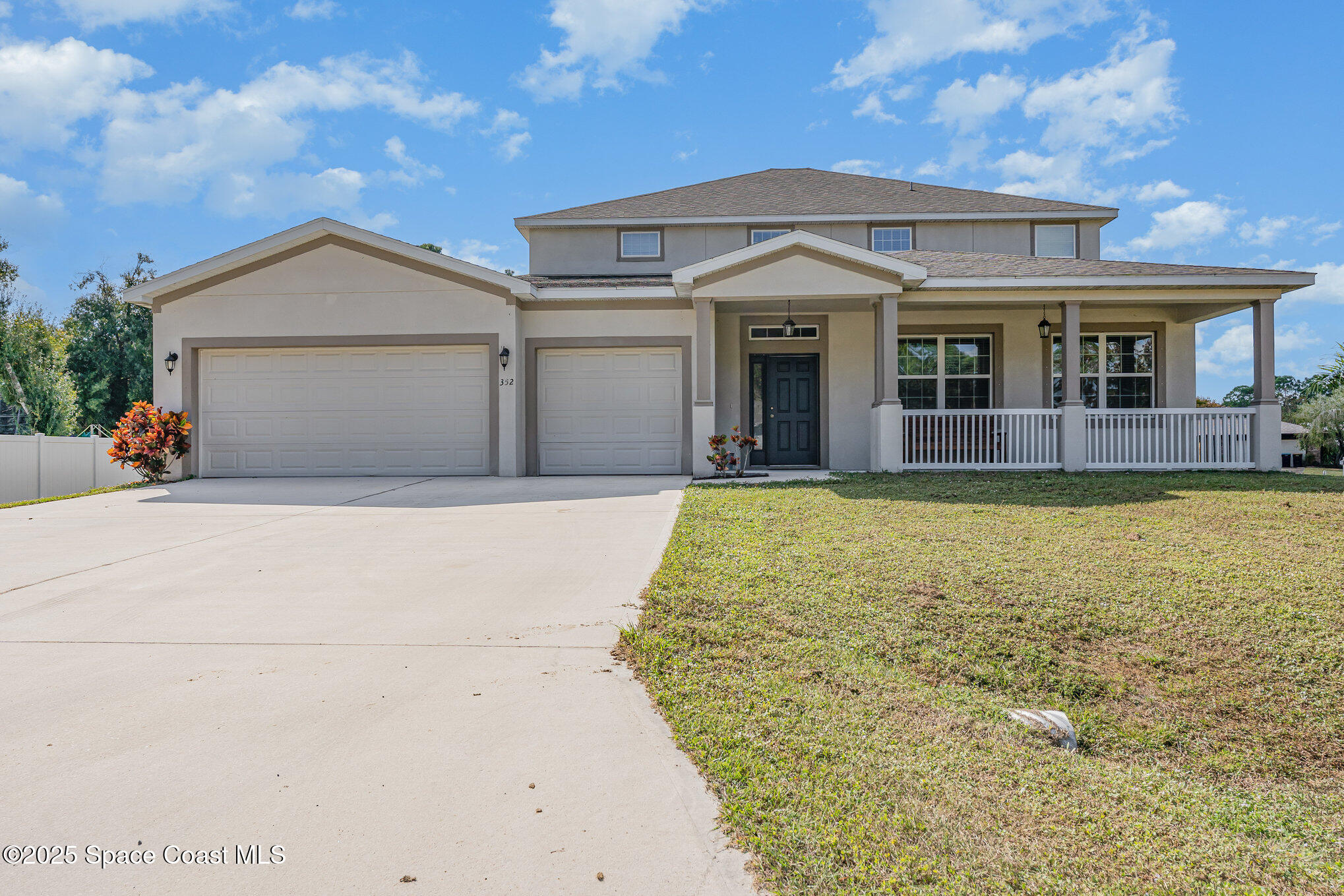 352 Gordon Road Northwest Palm Bay, FL 32907 - Photo 2 of 71 a front view of house with yard and trees in the background