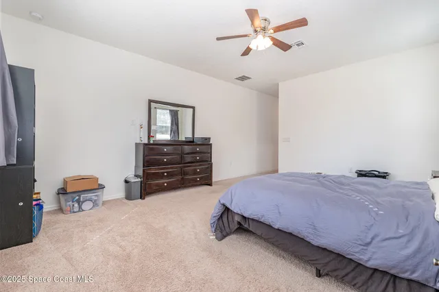 a bedroom with a bed dresser and a window