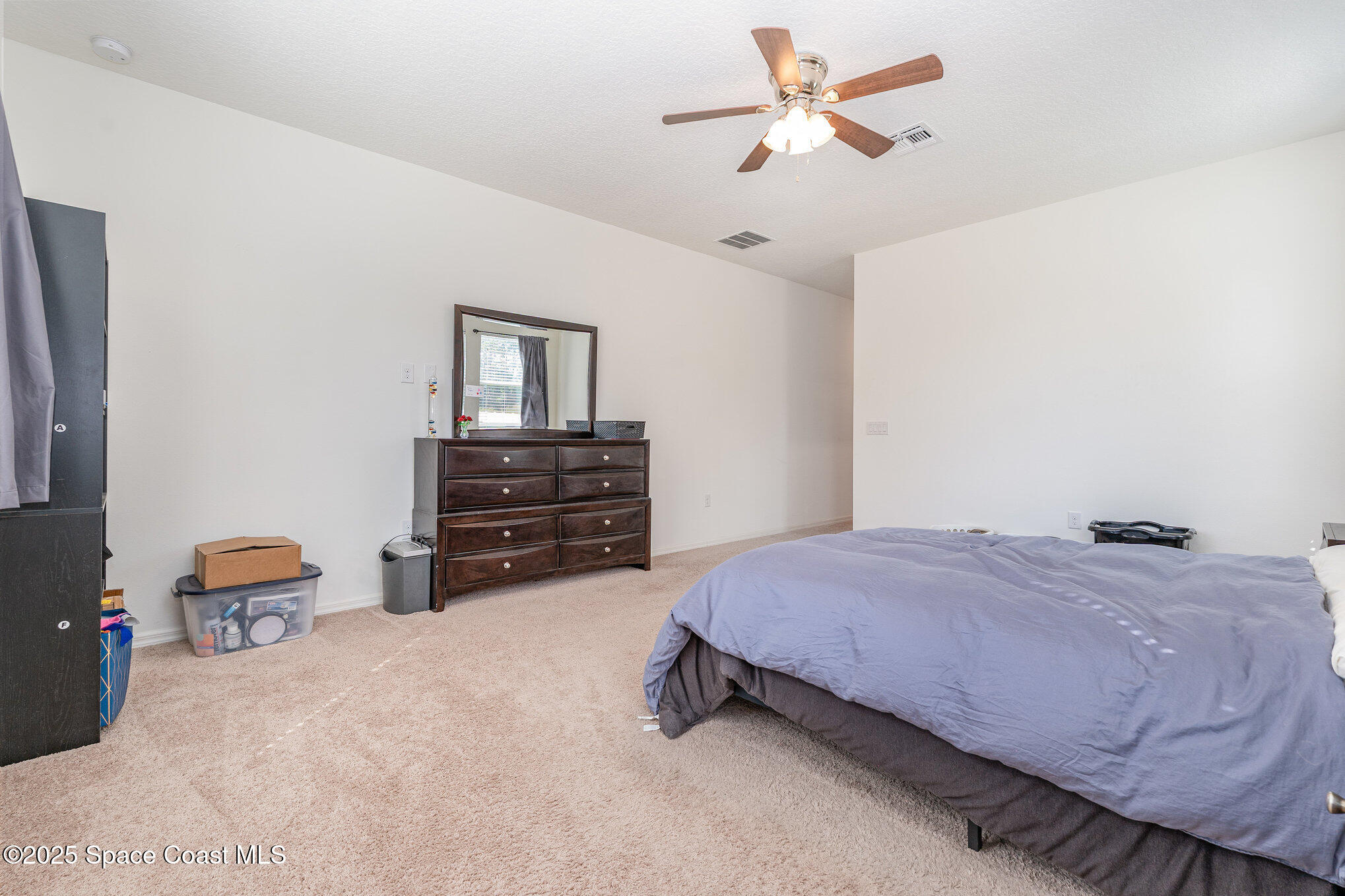 352 Gordon Road Northwest Palm Bay, FL 32907 - Photo 21 of 71 a bed room with a bed and a chandelier