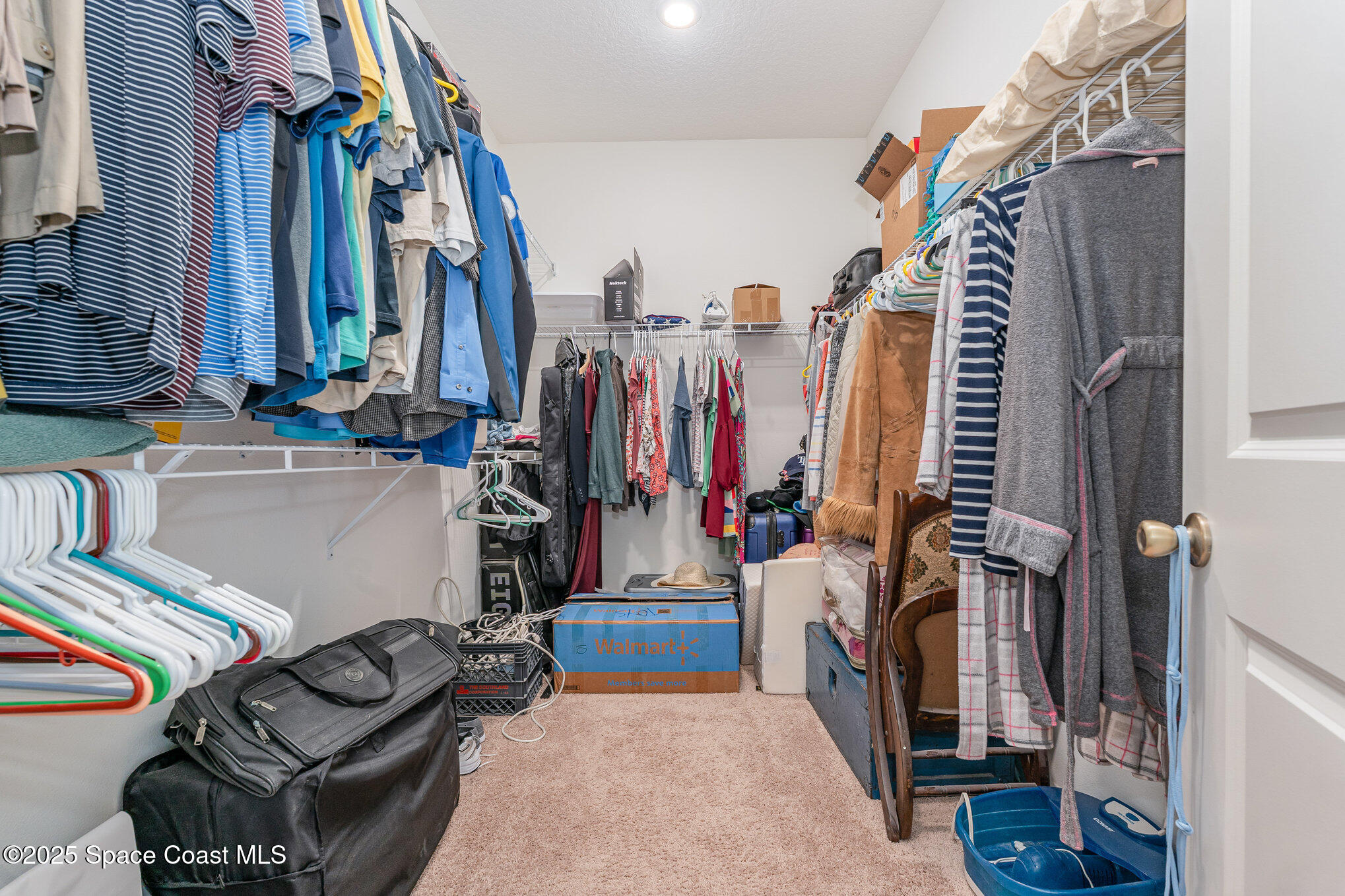 352 Gordon Road Northwest Palm Bay, FL 32907 - Photo 22 of 71 a view of walk in closet with clothes and shoes