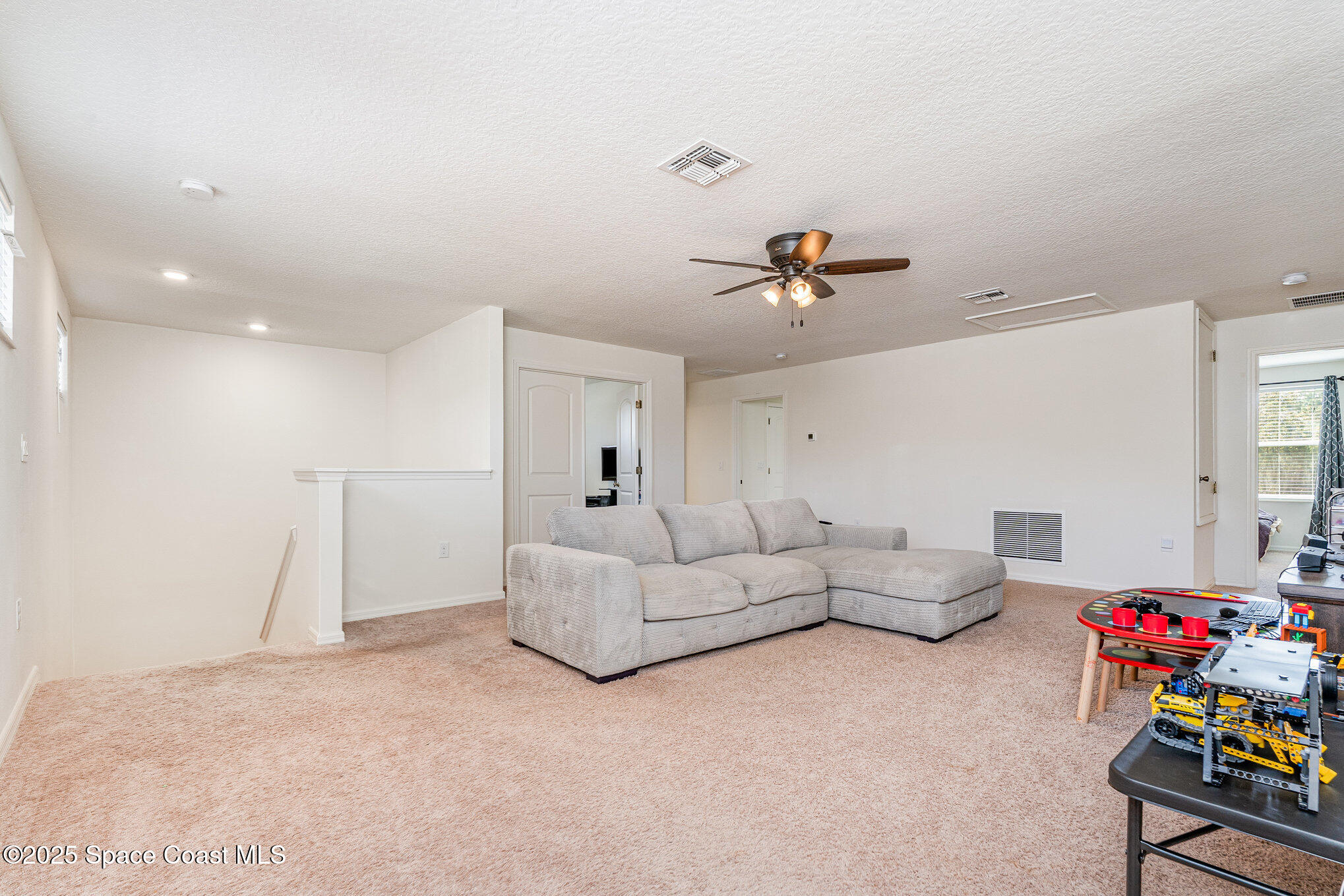 352 Gordon Road Northwest Palm Bay, FL 32907 - Photo 27 of 71 a living room with furniture and a chandelier