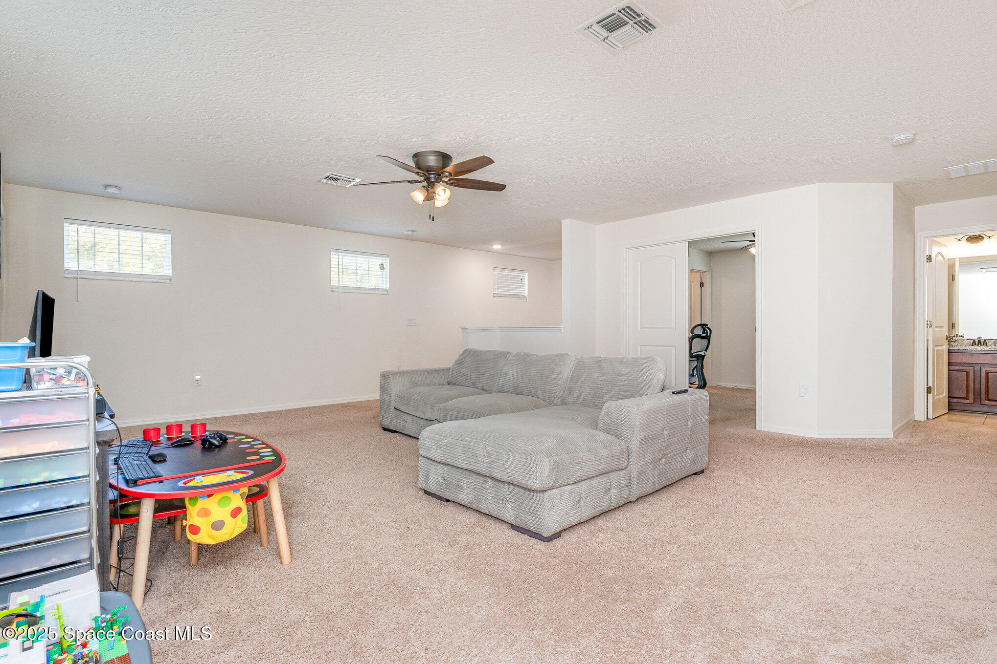 352 Gordon Road Northwest Palm Bay, FL 32907 - Photo 28 of 71 a living room with furniture and a flat screen tv