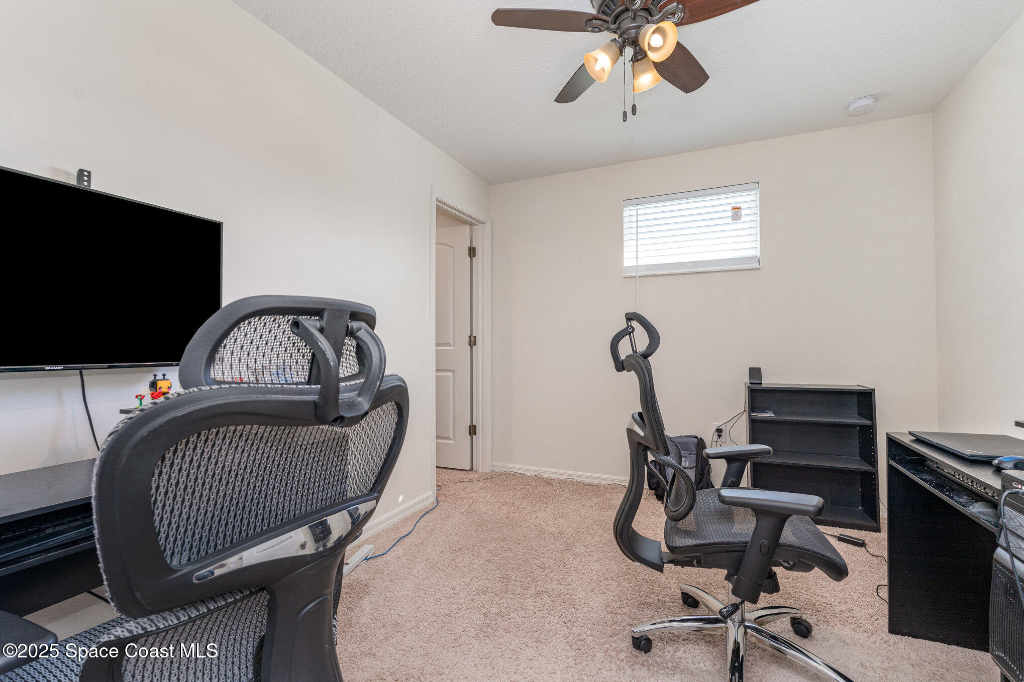 352 Gordon Road Northwest Palm Bay, FL 32907 - Photo 29 of 71 a view of a workspace with furniture and a window