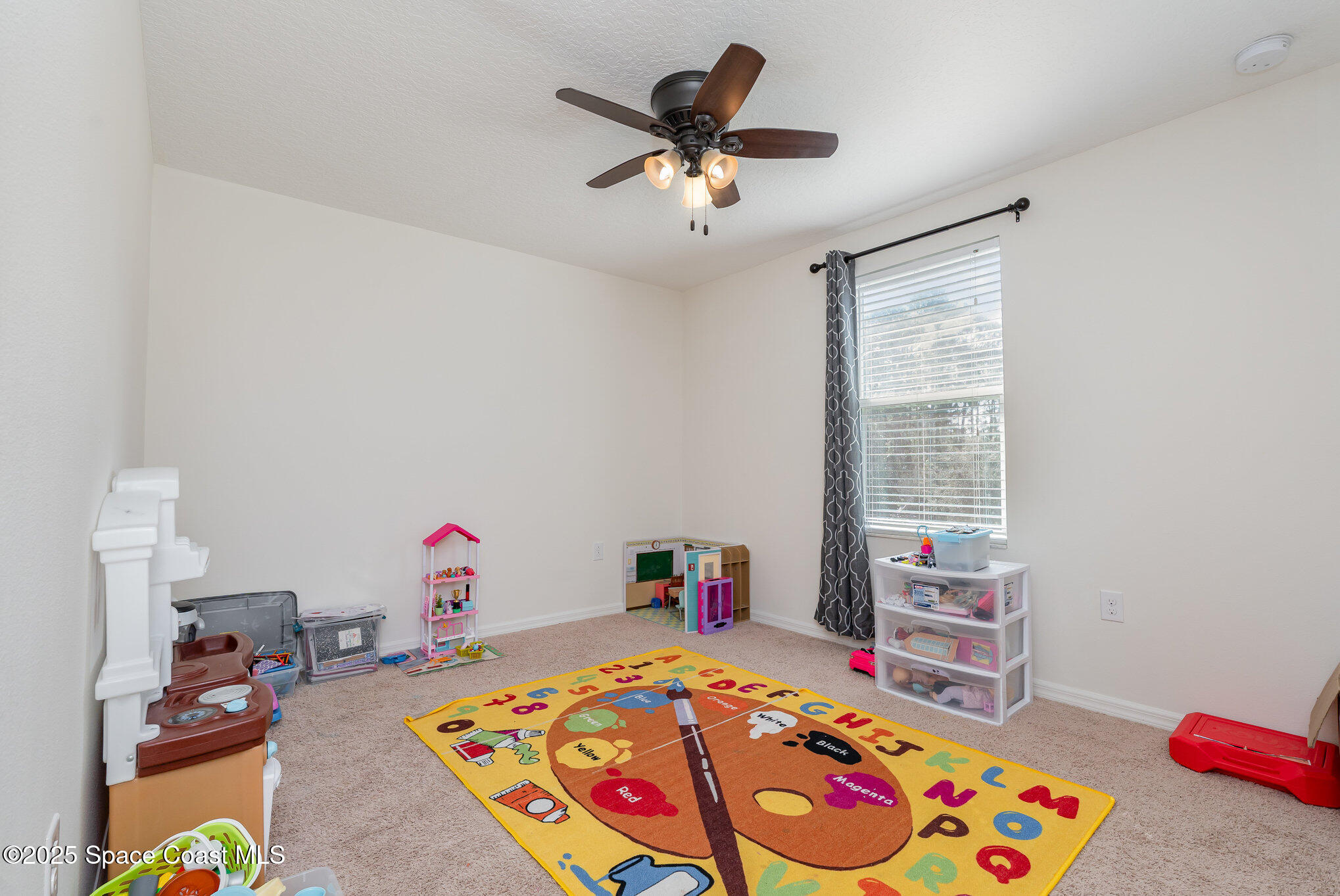 352 Gordon Road Northwest Palm Bay, FL 32907 - Photo 32 of 71 a bedroom with a bed and a chandelier