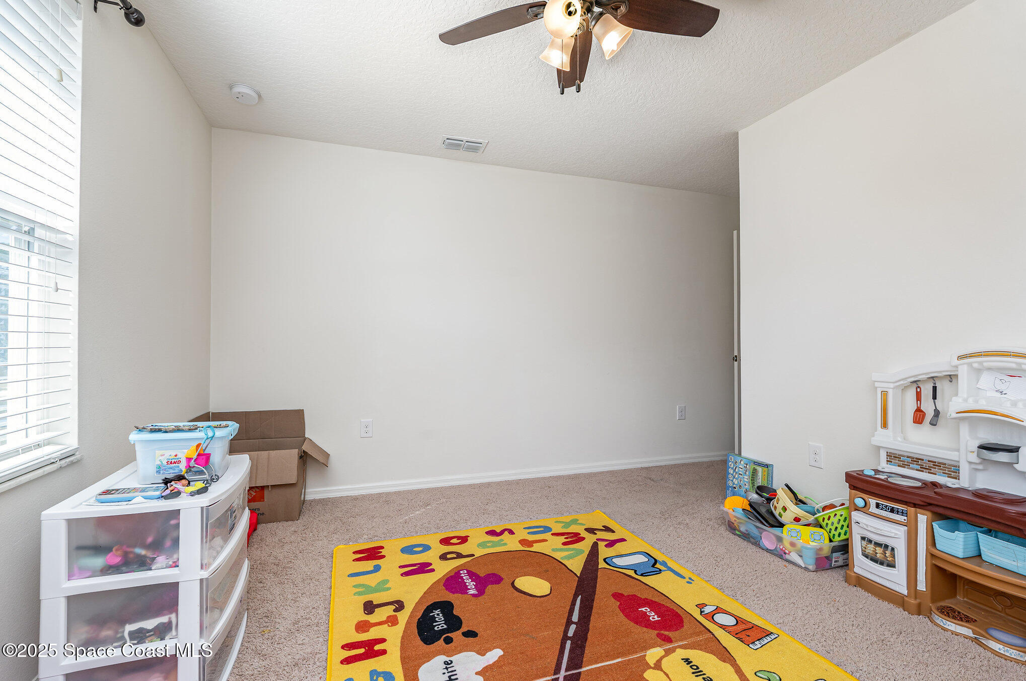 352 Gordon Road Northwest Palm Bay, FL 32907 - Photo 33 of 71 a bedroom with a bed and a dresser in it