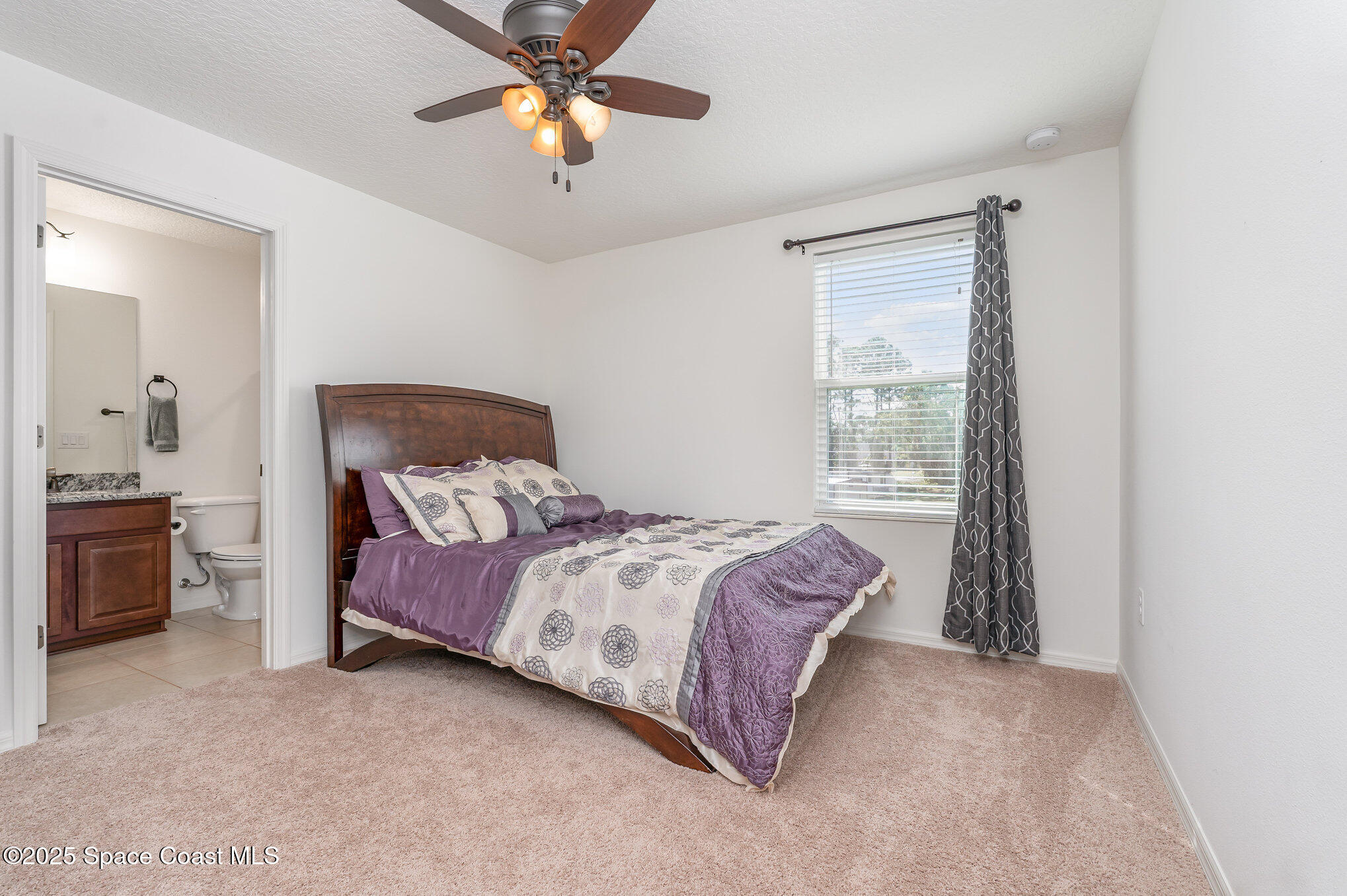 352 Gordon Road Northwest Palm Bay, FL 32907 - Photo 34 of 71 a bedroom with a bed dresser and a window