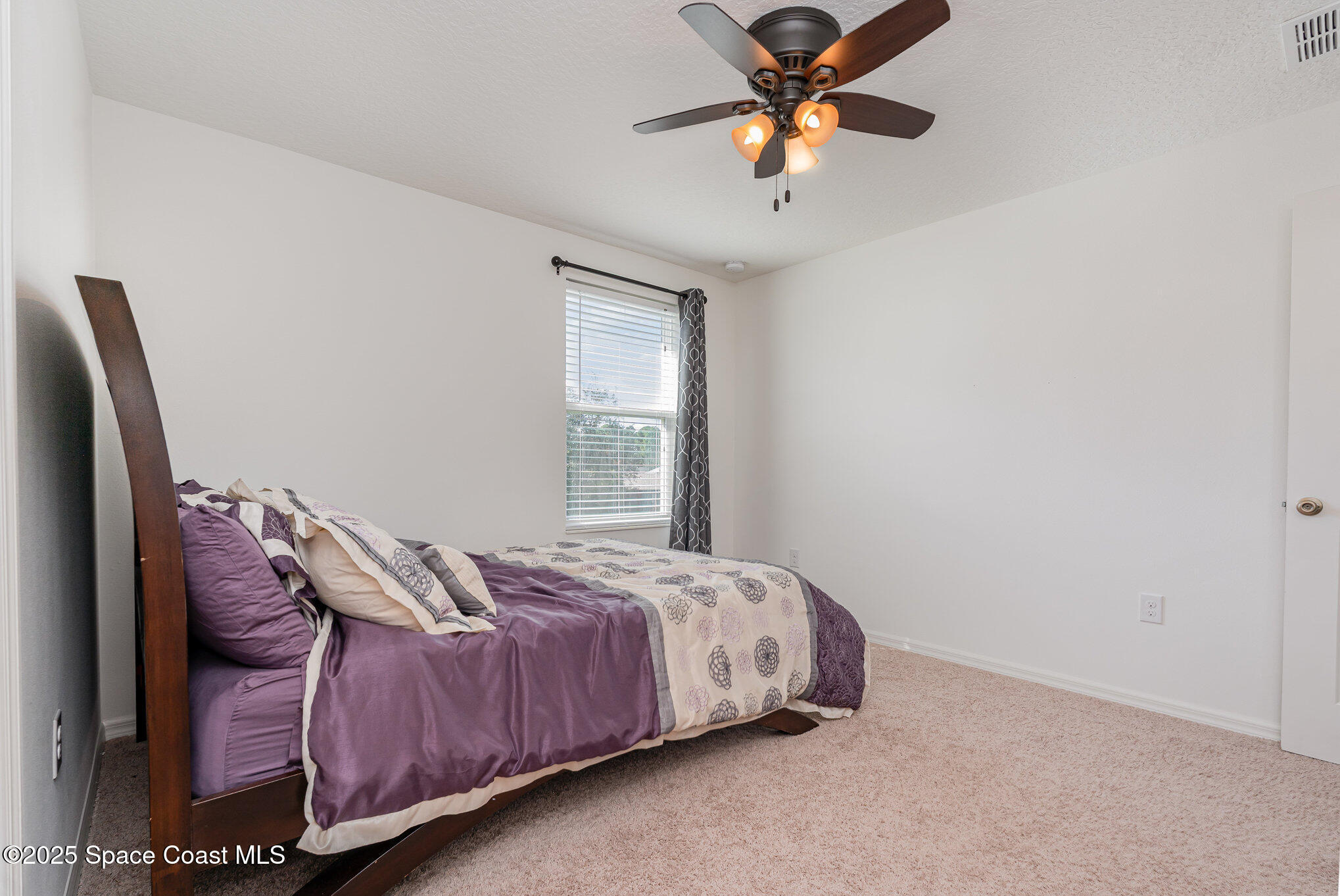 352 Gordon Road Northwest Palm Bay, FL 32907 - Photo 35 of 71 a bedroom with a bed and a chandelier