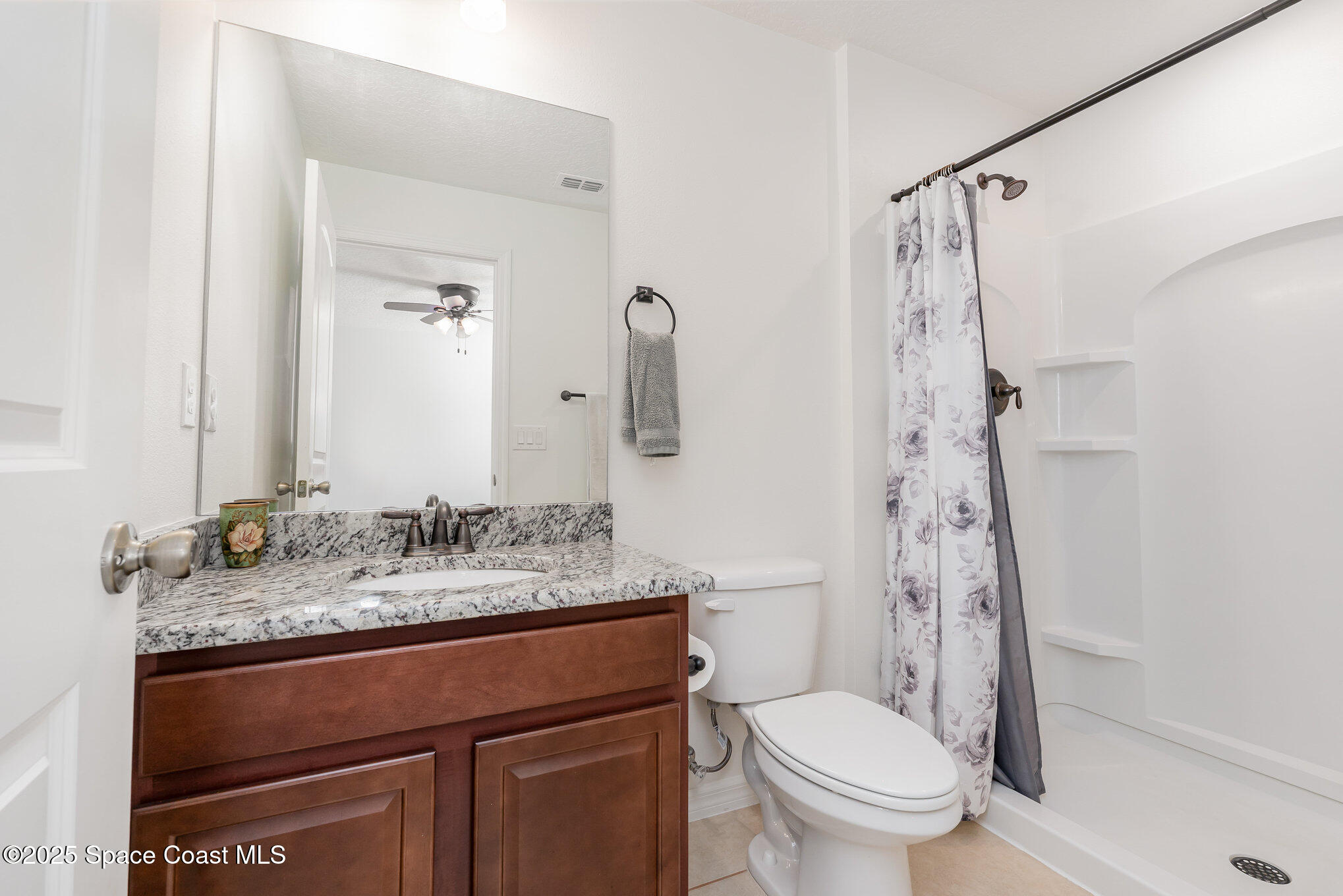 352 Gordon Road Northwest Palm Bay, FL 32907 - Photo 37 of 71 a bathroom with a granite countertop sink toilet and shower