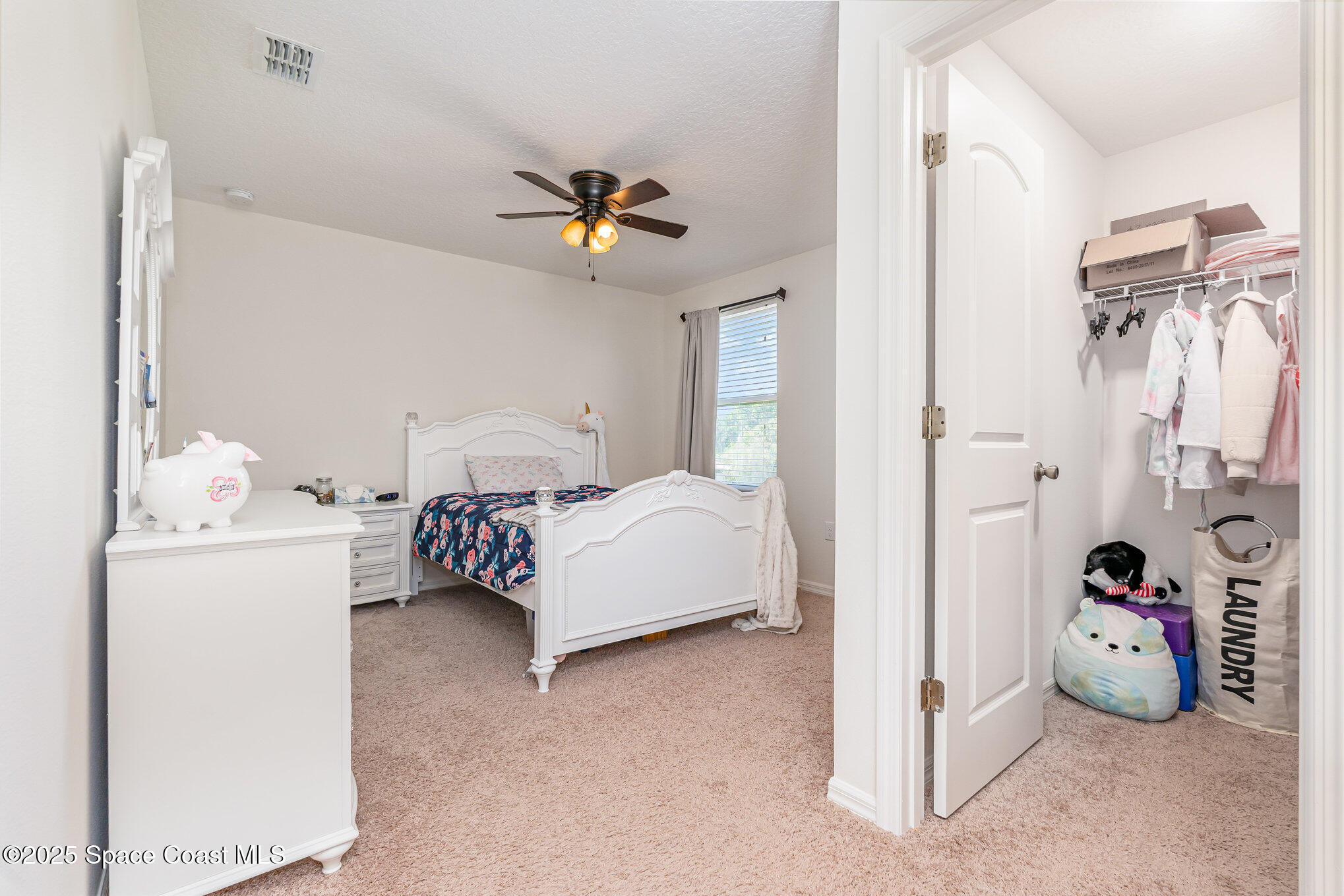 352 Gordon Road Northwest Palm Bay, FL 32907 - Photo 38 of 71 a bedroom with a bed and a chandelier