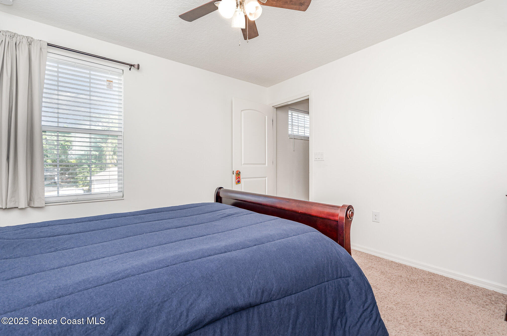 352 Gordon Road Northwest Palm Bay, FL 32907 - Photo 40 of 71 a bedroom with a bed and a chandelier fan