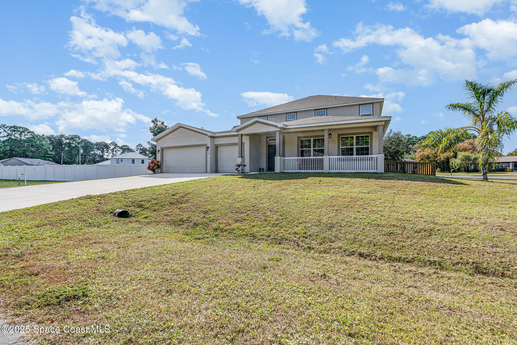 352 Gordon Road Northwest Palm Bay, FL 32907 - Photo 4 of 71 a view of a house with a big yard and large trees