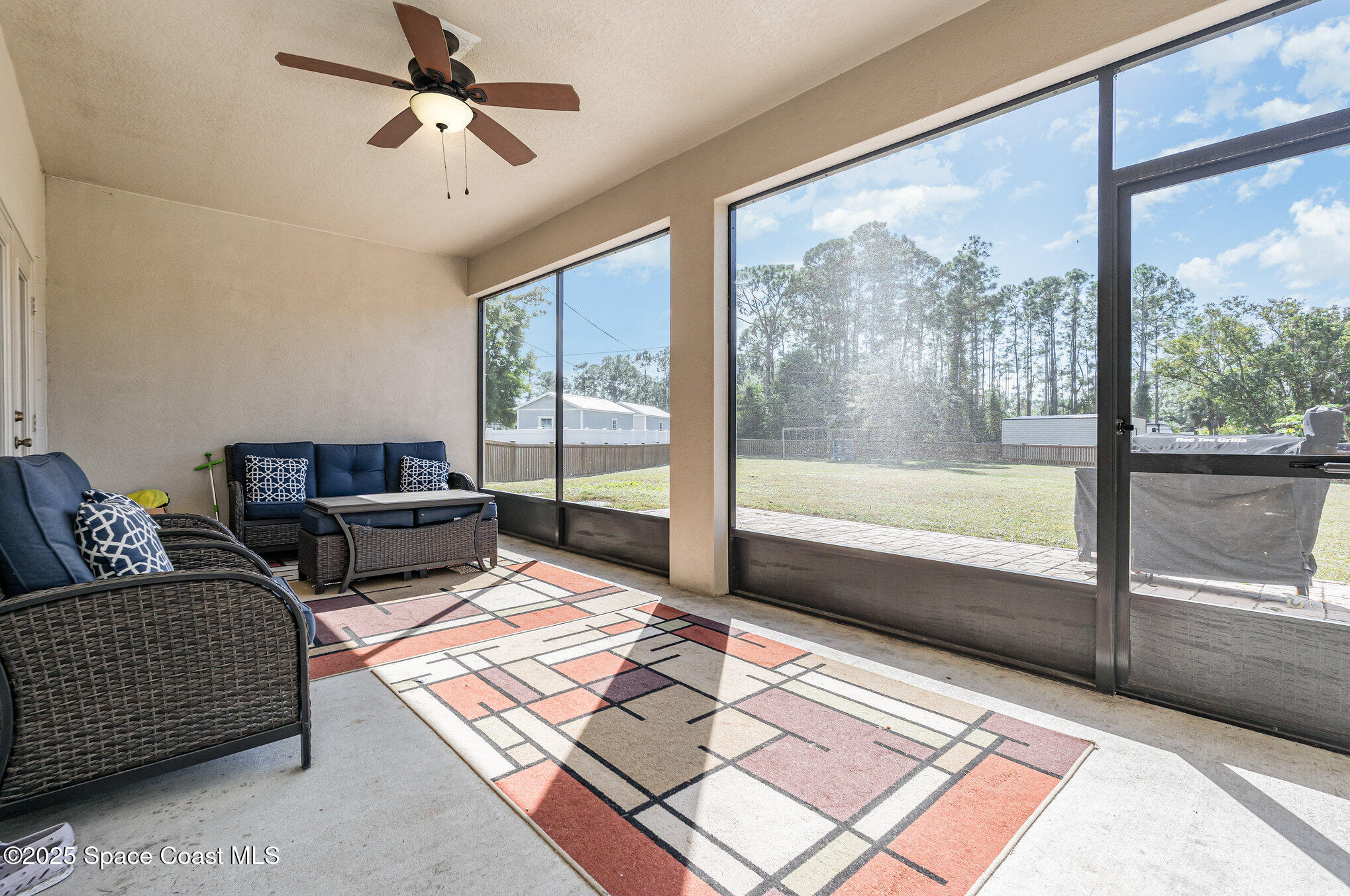 352 Gordon Road Northwest Palm Bay, FL 32907 - Photo 45 of 71 a living room with couch and a floor to ceiling window