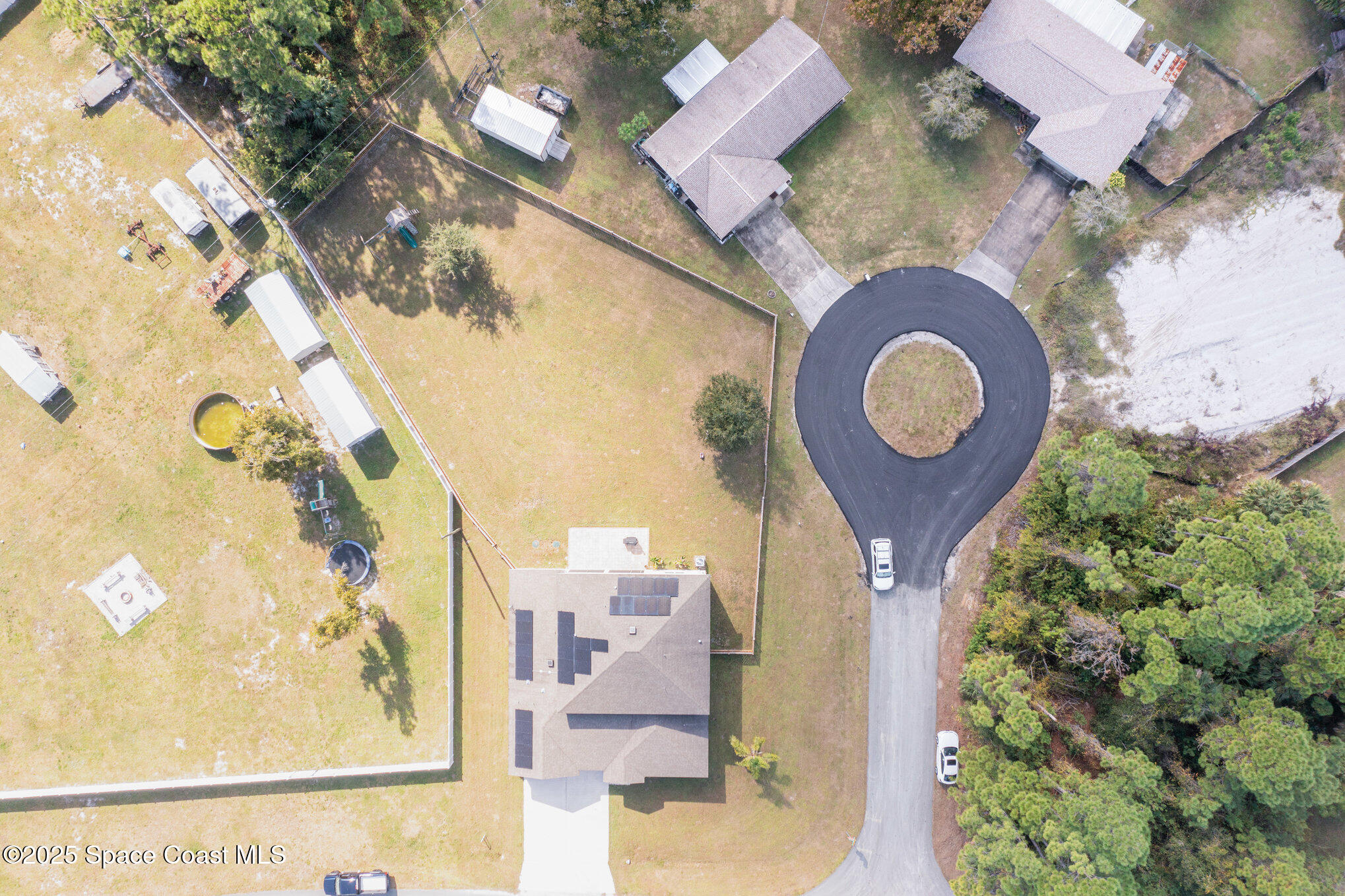 352 Gordon Road Northwest Palm Bay, FL 32907 - Photo 61 of 71 an aerial view of a house with garden space and wooden deck