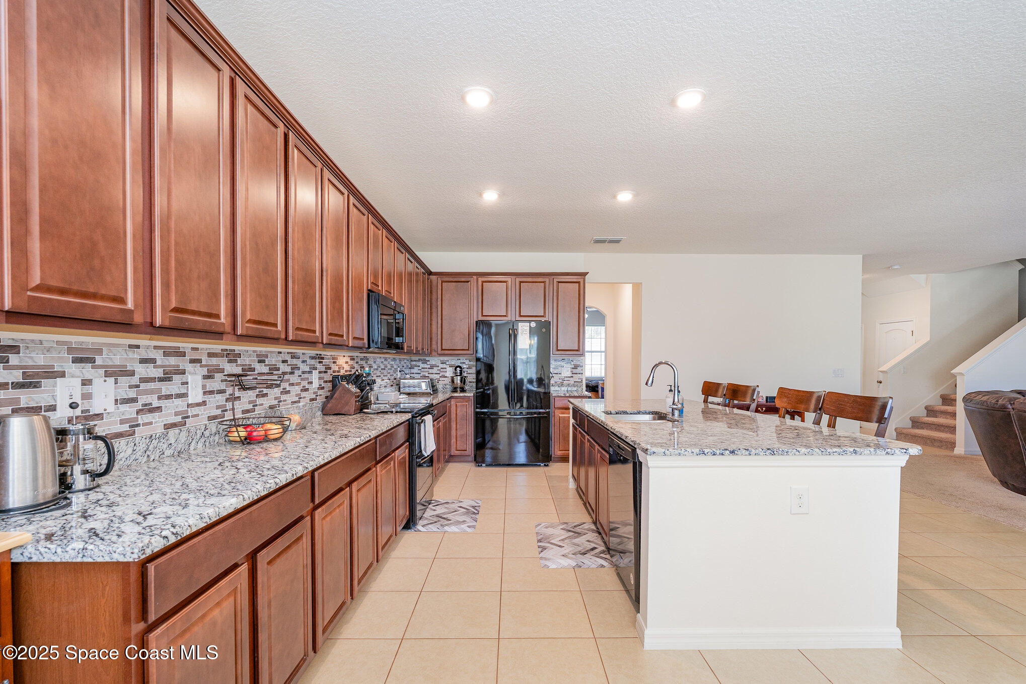 352 Gordon Road Northwest Palm Bay, FL 32907 - Photo 7 of 71 a kitchen with stainless steel appliances granite countertop a sink stove and cabinets