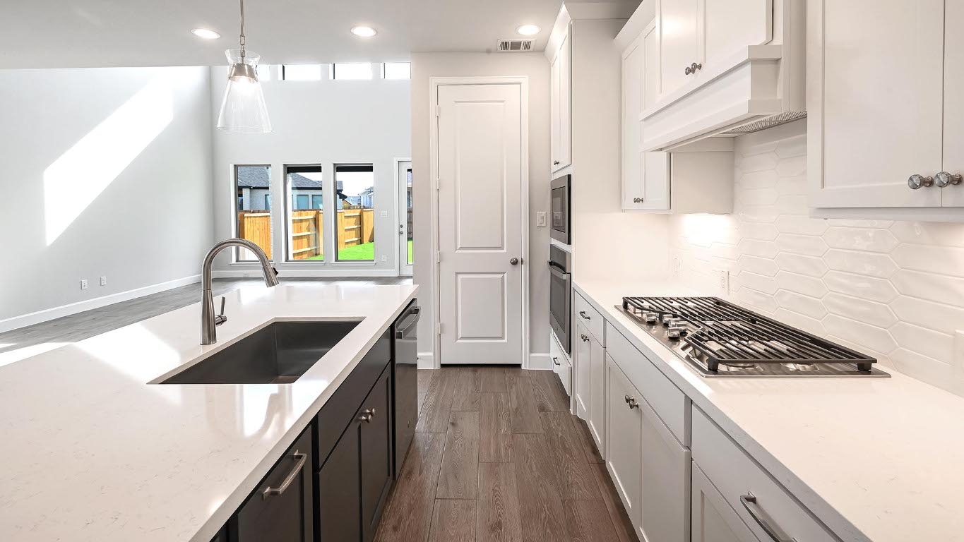 285 Prickly Poppy Loop Kyle, TX 78640 - Photo 15 of 40 Kitchen featuring dark cabinets, dark wood-style floors, recessed lighting, light stone countertops, and white cabinetry