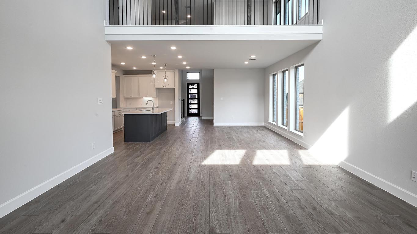 285 Prickly Poppy Loop Kyle, TX 78640 - Photo 21 of 40 Unfurnished living room featuring recessed lighting, dark wood-type flooring, and a towering ceiling