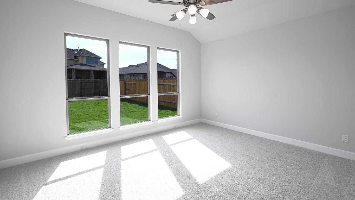 285 Prickly Poppy Loop Kyle, TX 78640 - Photo 10 of 40 Empty room with carpet floors, ceiling fan, and vaulted ceiling