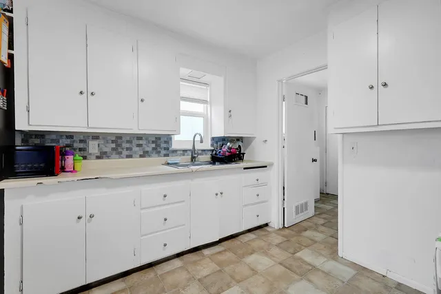 a view of a house with a yard and garage