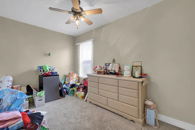 a kitchen with a sink dishwasher and white cabinets with wooden floor