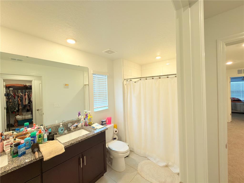 253 Tulip Banded Way Ruskin, FL 33570 - Photo 16 of 20 a bathroom with a sink vanity mirror and toilet