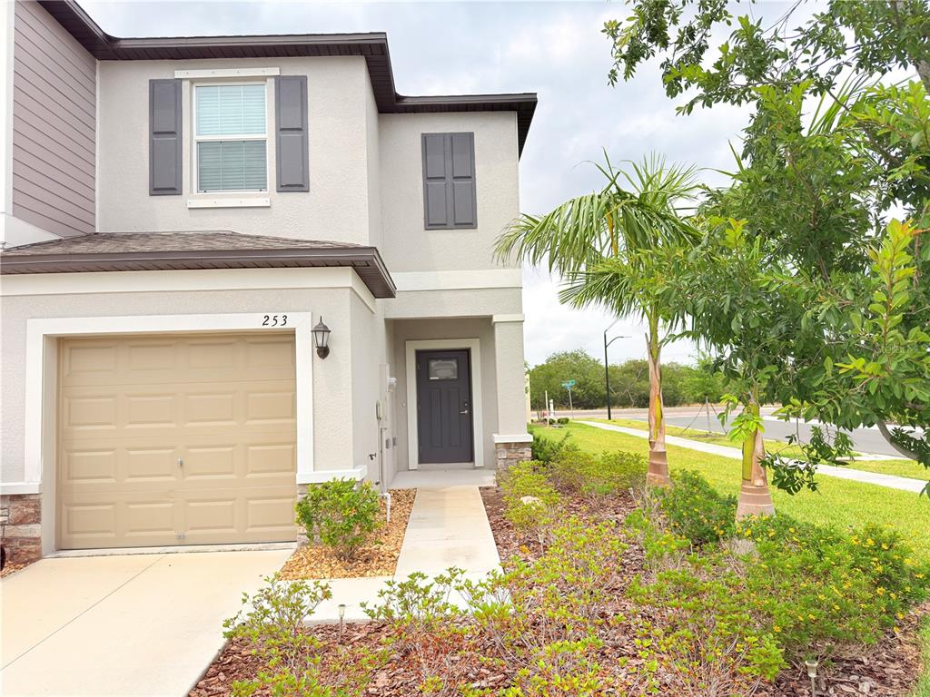 253 Tulip Banded Way Ruskin, FL 33570 - Photo 7 of 20 a view of a house with a small yard and plants