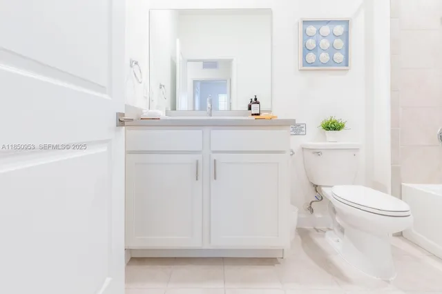 a bathroom with a sink a toilet and mirror