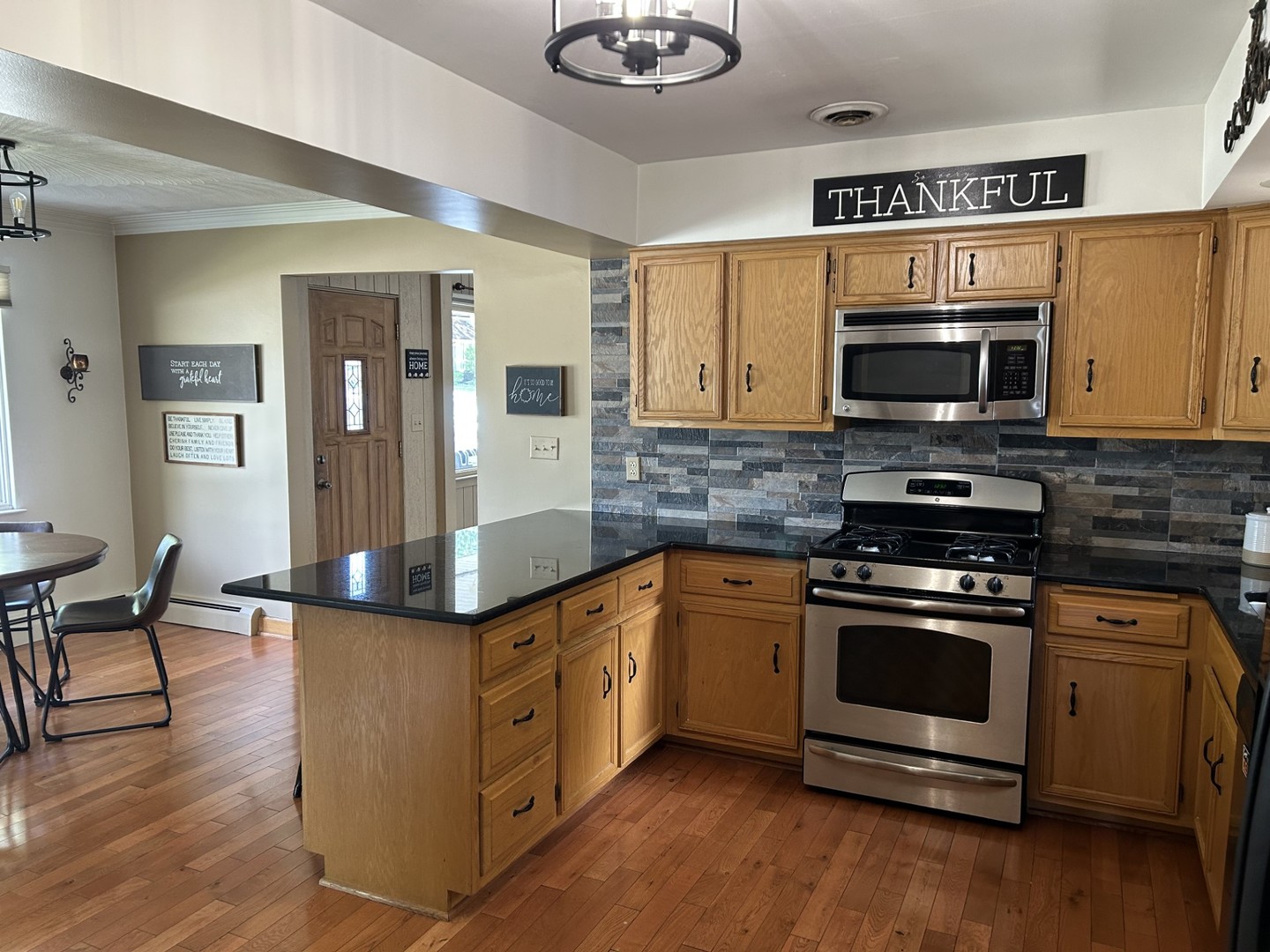 900 Read Street Lockport, IL 60441 - Photo 7 of 23 a kitchen with stainless steel appliances granite countertop a stove a sink and a microwave