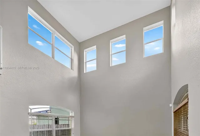 a view of a hallway with wooden floor and entryway