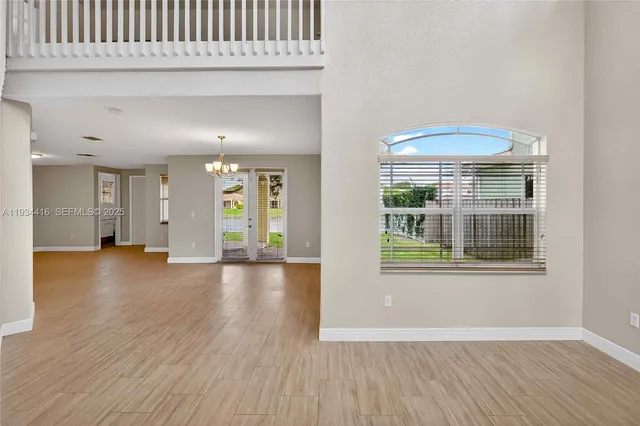 a view of a room with wooden floor