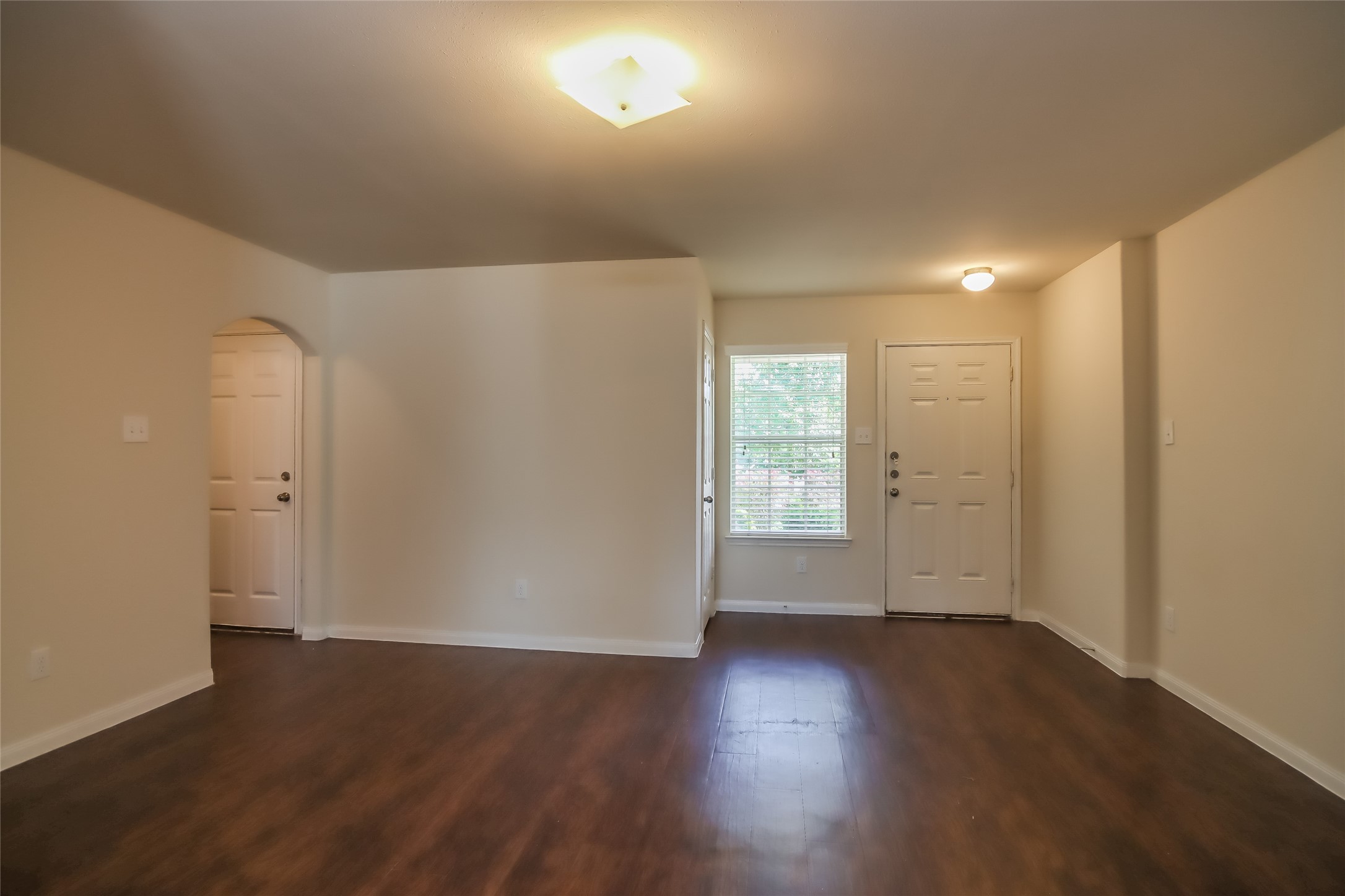 13022 Ristina Circle Houston, TX 77048 - Photo 7 of 15 wooden floor in an empty room with a window