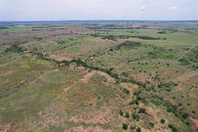 an aerial view of a houses with a yard
