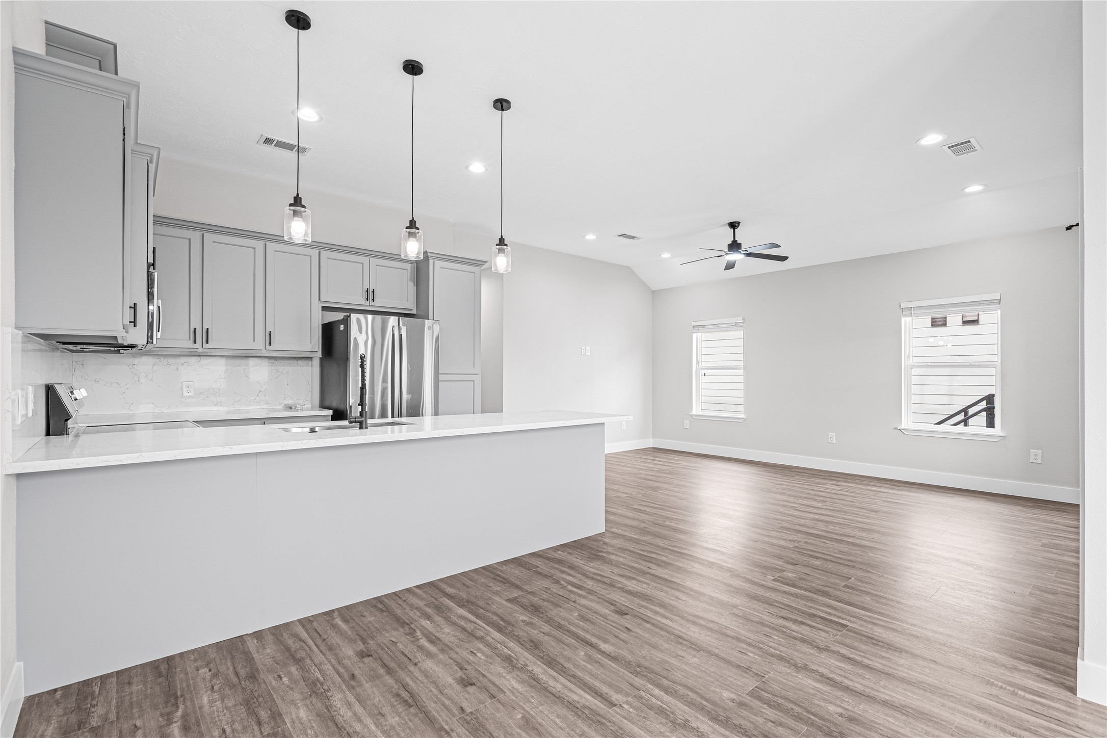 3821 Easy Street, Unit B Houston, TX 77026 - Photo 4 of 10 a kitchen with stainless steel appliances granite countertop a sink a window and wooden floor