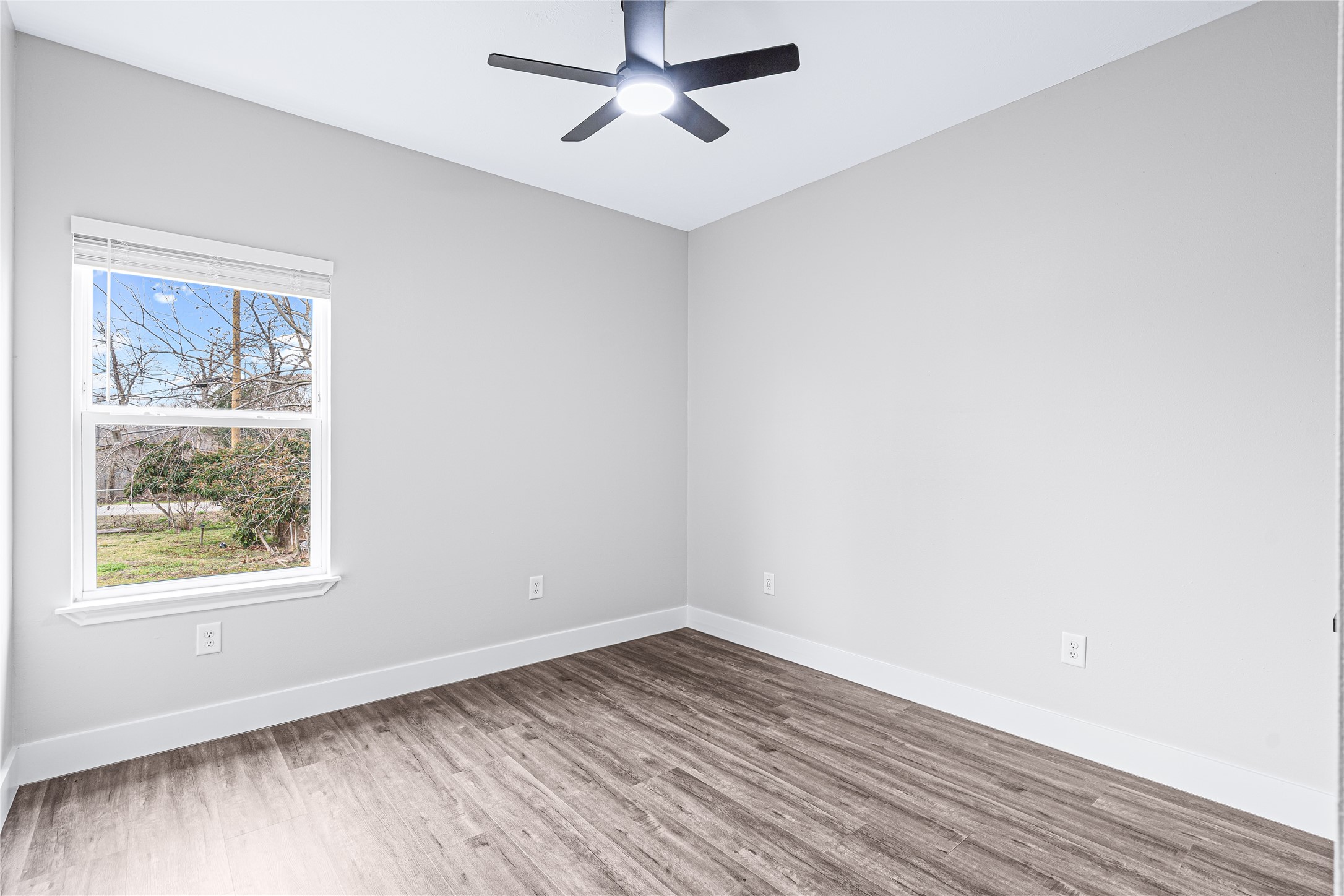 3821 Easy Street, Unit B Houston, TX 77026 - Photo 9 of 10 an empty room with a window and wooden floor