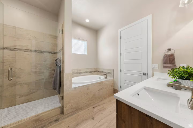 2600 Ocotillo Way, Unit 56 Santa Clara, UT 84765 - Photo 14 of 33 Full bath with a bath, a shower stall, double vanity, and light wood-style flooring