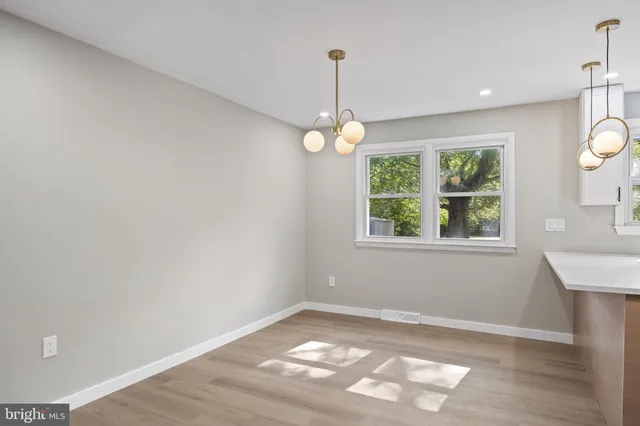 an empty room with window and mirror