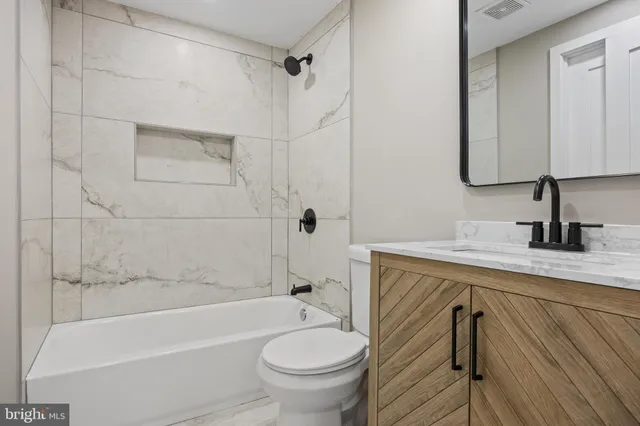 a bathroom with a sink a toilet and a bathtub