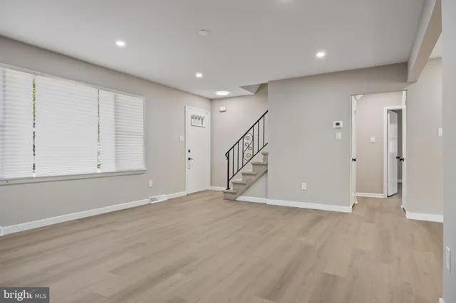 a view of an empty room with wooden floor