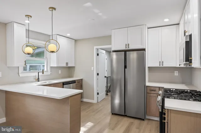 a kitchen with refrigerator and cabinets