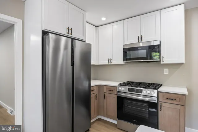 a kitchen with stainless steel appliances a stove a microwave and a refrigerator