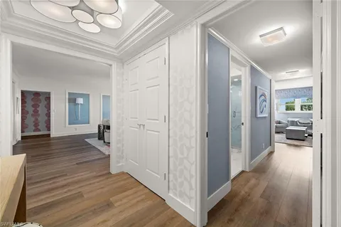 a view of a hallway view with wooden floor and staircase