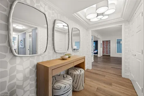 a view of a livingroom with furniture mirror and fan