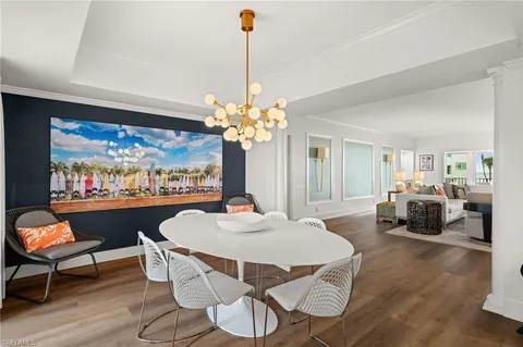 a living room with furniture a chandelier and a fireplace